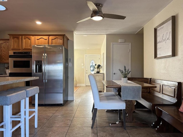 dining room featuring ceiling fan and light tile patterned floors