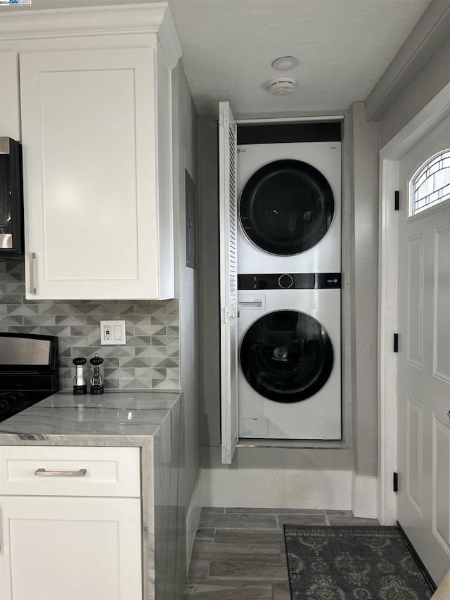 laundry area featuring stacked washing maching and dryer