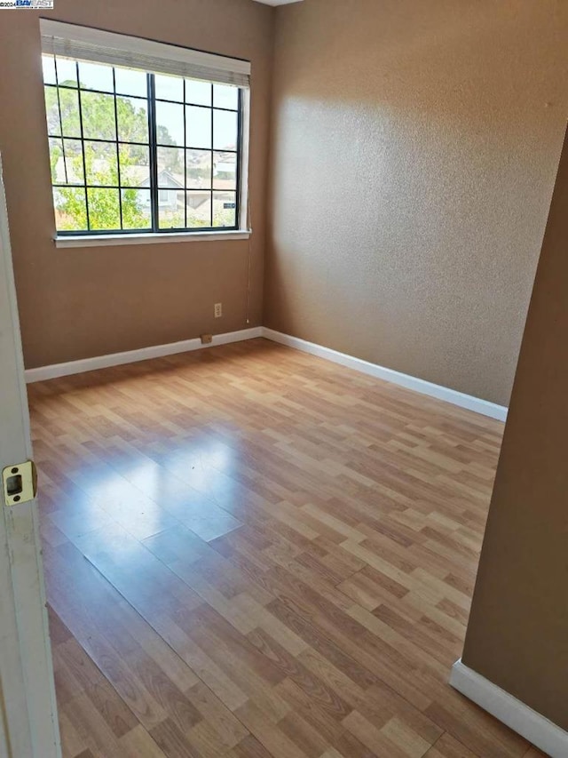 unfurnished room featuring light wood-type flooring