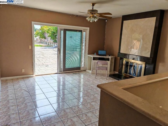 living room with ceiling fan and light tile patterned floors