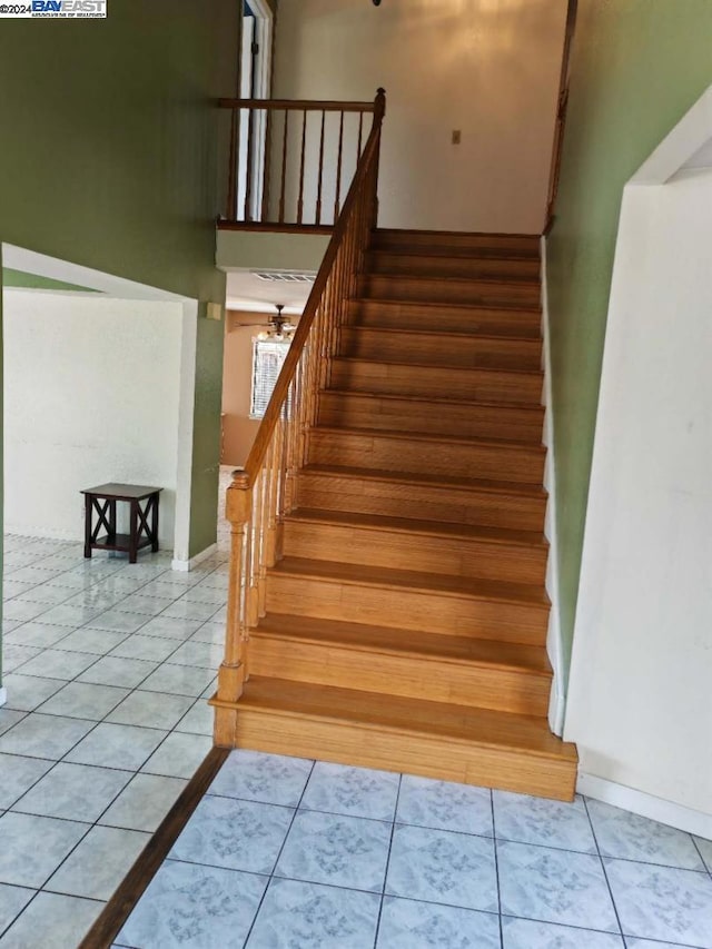 staircase featuring tile patterned flooring