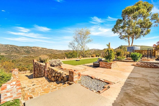 view of patio / terrace featuring a mountain view