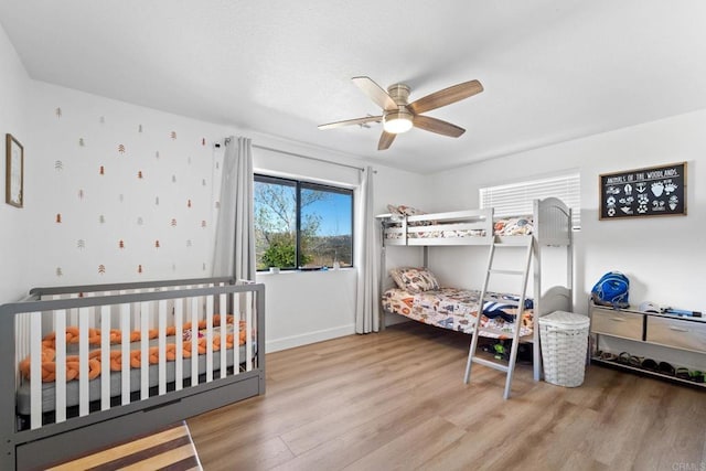 bedroom featuring hardwood / wood-style flooring and ceiling fan