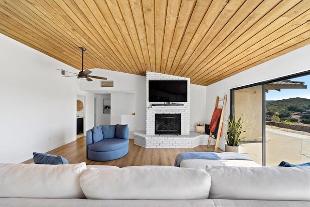 living room with wood-type flooring, lofted ceiling, a brick fireplace, and wooden ceiling