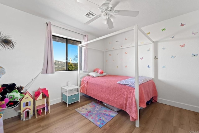 bedroom with hardwood / wood-style flooring and ceiling fan