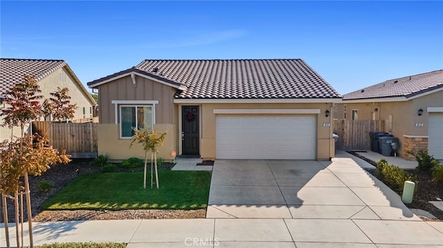 view of front of property featuring a garage and a front yard