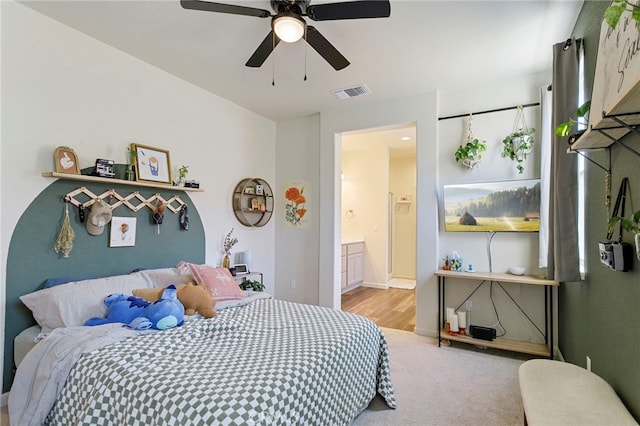 bedroom featuring ensuite bath, ceiling fan, and light colored carpet