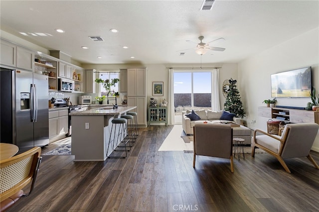 living room featuring dark hardwood / wood-style floors, ceiling fan, and sink