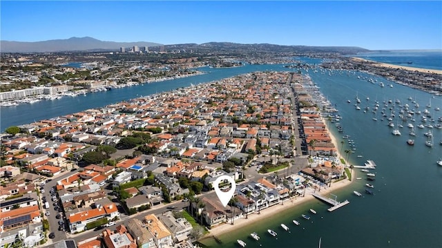 birds eye view of property with a water and mountain view