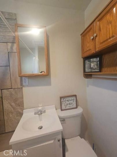 bathroom featuring vanity and toilet