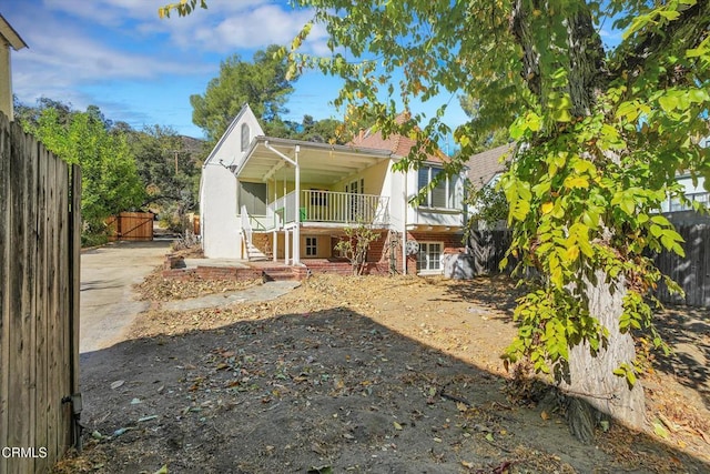 back of house featuring covered porch