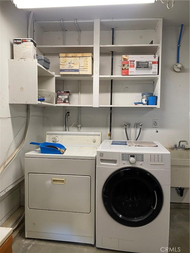 laundry area featuring separate washer and dryer and sink