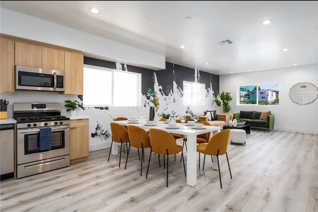 dining space featuring light wood-type flooring