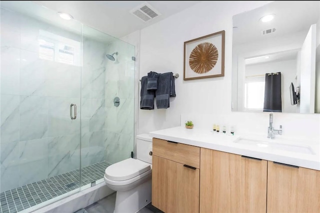 bathroom with toilet, plenty of natural light, vanity, and walk in shower