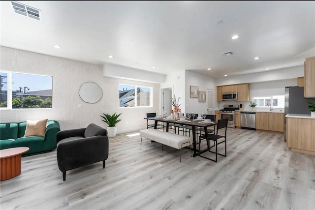 dining area featuring light hardwood / wood-style floors and sink