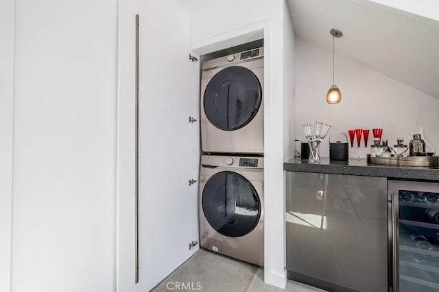 laundry area with bar area, wine cooler, and stacked washer / drying machine