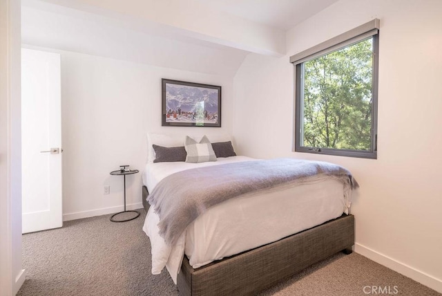 bedroom featuring beamed ceiling and carpet floors