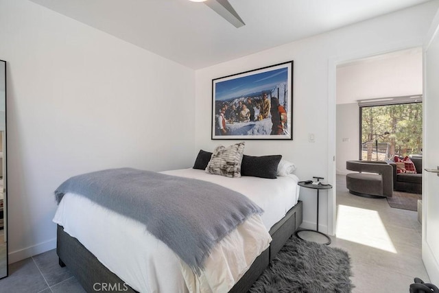 tiled bedroom featuring ceiling fan