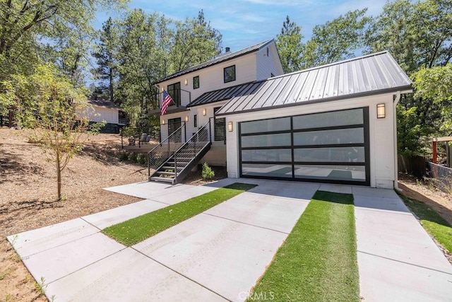 modern inspired farmhouse with a balcony and a garage