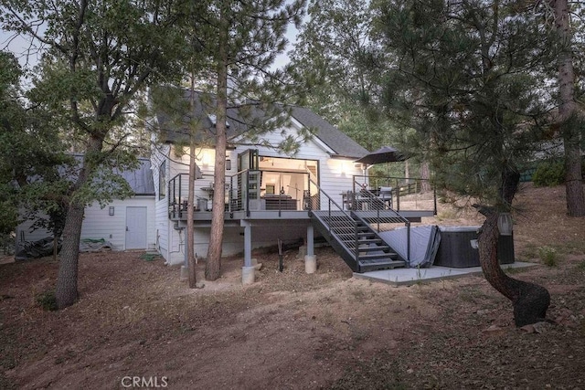 rear view of property featuring a deck