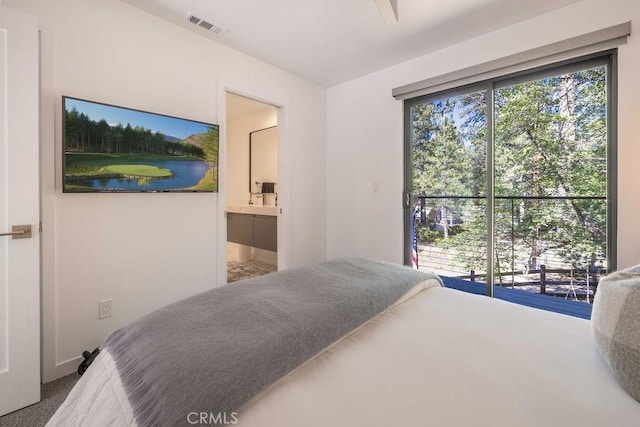 bedroom featuring carpet, access to exterior, and ensuite bath