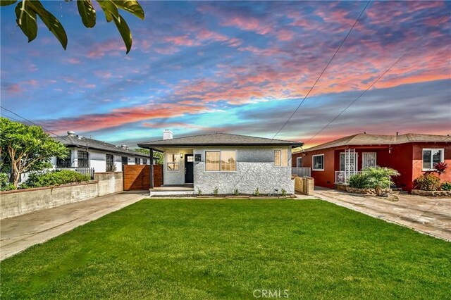 view of front of house with a yard