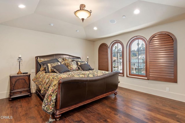 bedroom featuring dark wood-type flooring and vaulted ceiling