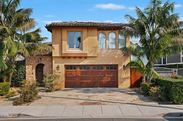 mediterranean / spanish house with a garage