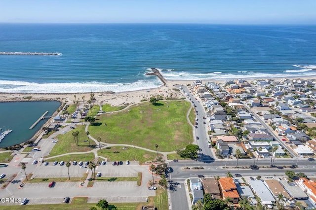 birds eye view of property with a water view and a view of the beach