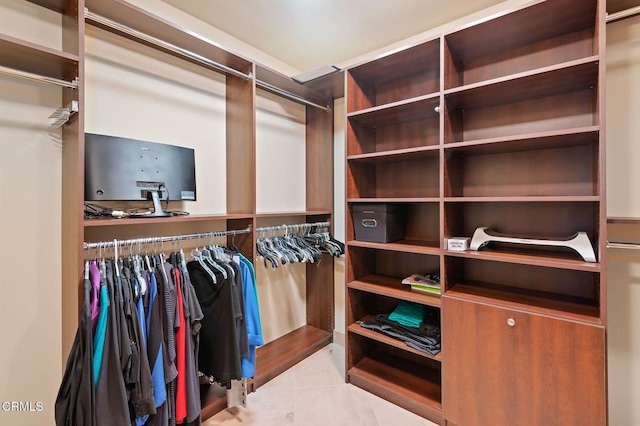 spacious closet featuring light tile patterned floors