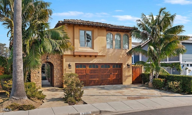 mediterranean / spanish house featuring a garage