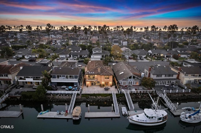 aerial view at dusk with a water view