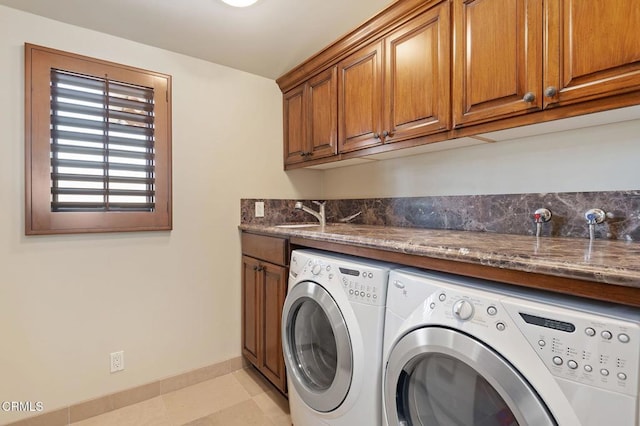 washroom featuring cabinets, independent washer and dryer, and sink