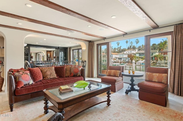 tiled living room with beamed ceiling and plenty of natural light