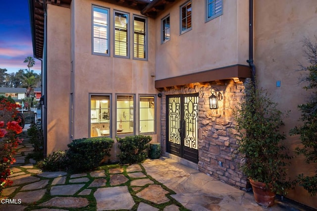 exterior entry at dusk with french doors