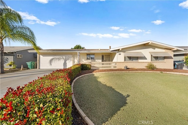 ranch-style home featuring a garage and a front lawn