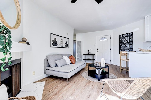 living room with ceiling fan and light hardwood / wood-style floors