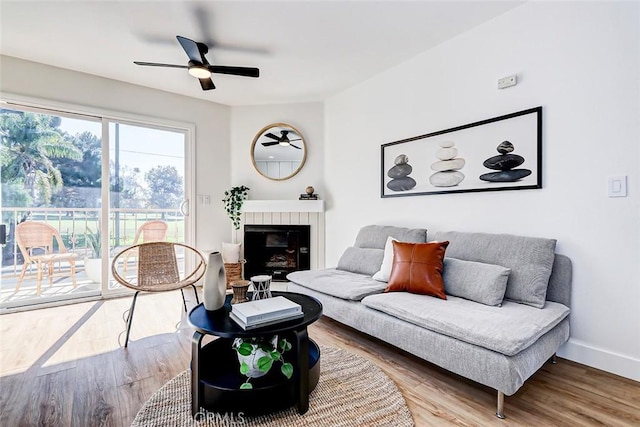 living room featuring hardwood / wood-style flooring and ceiling fan