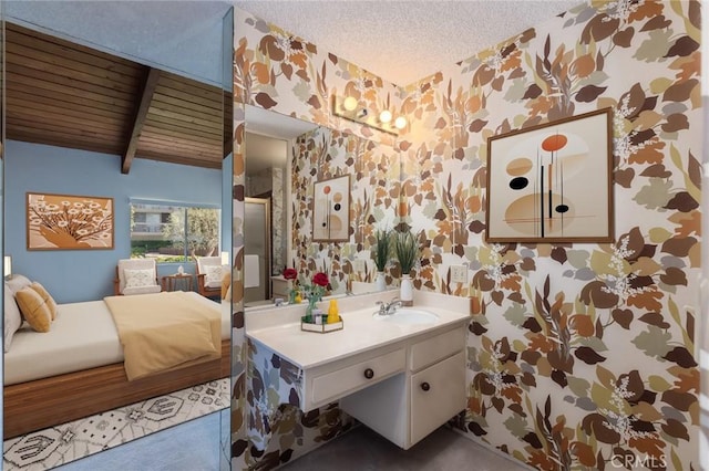 6542 Ocean Crest Dr Unit C-309, Rancho Palos Verdes, CA 90275 - bathroom featuring wallpapered walls, vanity, a textured ceiling, and beamed ceiling