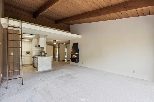6542 Ocean Crest Dr Unit C-309, Rancho Palos Verdes, CA 90275 - unfurnished living room featuring a wooden ceiling with exposed beams, light colored carpet, a warm lit fireplace, and a ceiling fan