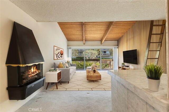 6542 Ocean Crest Dr Unit C-309, Rancho Palos Verdes, CA 90275 - living room with carpet, a wooden ceiling with exposed beams, and a warm lit fireplace