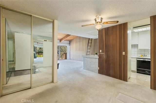 6542 Ocean Crest Dr Unit C-309, Rancho Palos Verdes, CA 90275 - corridor featuring light colored carpet, wood walls, a textured ceiling, and beamed ceiling