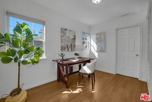 dining room featuring light hardwood / wood-style flooring and a healthy amount of sunlight