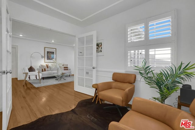 sitting room featuring wood-type flooring and french doors