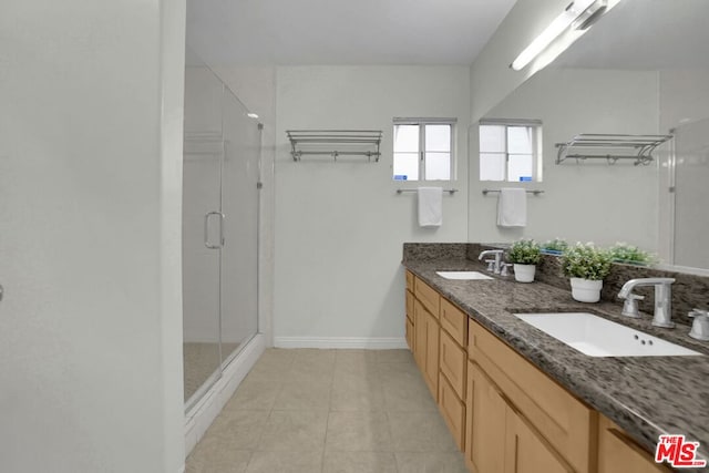 bathroom featuring vanity, tile patterned floors, and a shower with door