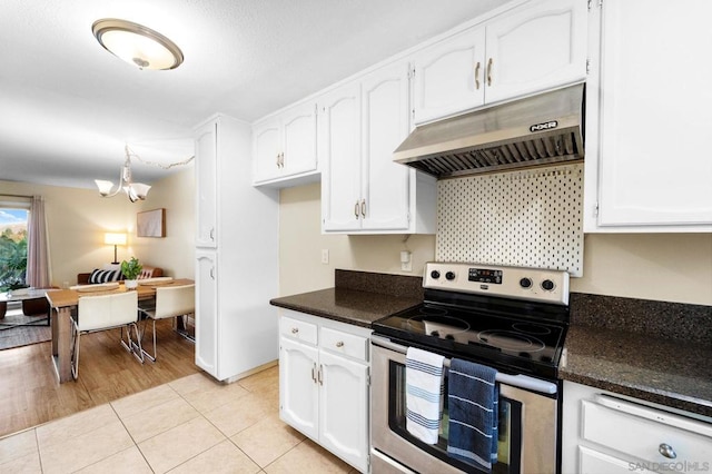 kitchen featuring dark stone counters, electric range, light hardwood / wood-style flooring, a chandelier, and white cabinetry