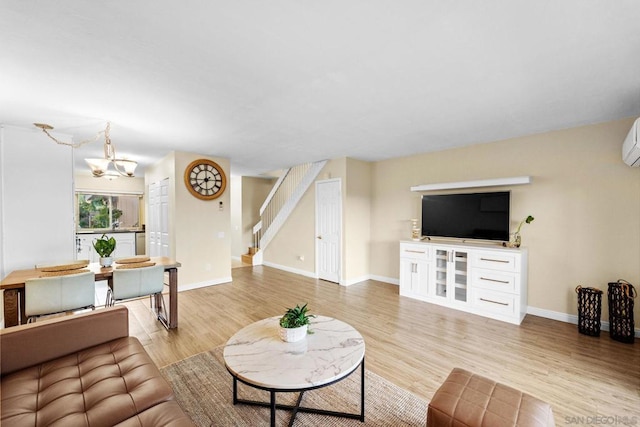 living room featuring a chandelier and light hardwood / wood-style floors