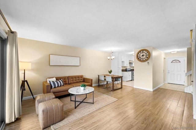 living room with a chandelier and light wood-type flooring