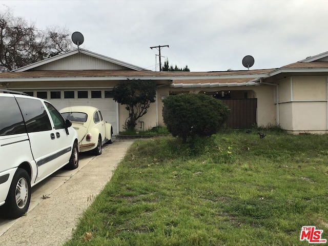 view of side of home with a garage and a lawn