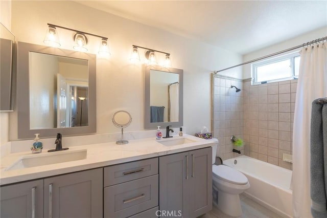 full bathroom with shower / bath combo with shower curtain, vanity, and toilet